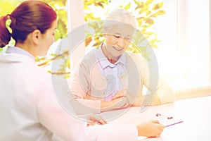 Doctor with clipboard and senior woman at hospital