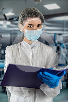 doctor in clipboard to write to record patient's diagnosis in clinic room.