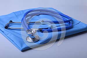 Doctor coat with medical stethoscope on the desk