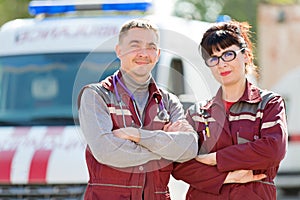 Doctor with colleague paramedic on ambulance vehicle background