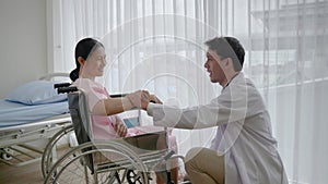 Doctor comforting patient in wheelchair due to accident, health concept ,health insurance , life insurance, accident insurance