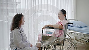 Doctor comforting patient in wheelchair due to accident, health concept ,health insurance , life insurance, accident insurance