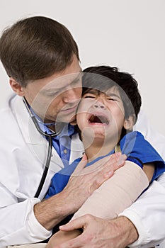 Doctor comforting a scared little boy