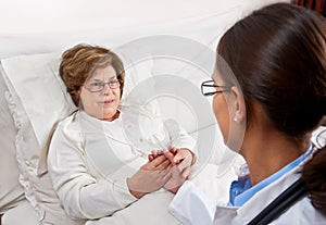 Doctor comforting senior patient