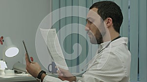 Doctor communicate by video conferention on tablet pc, discuss documents