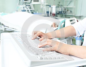 Doctor at the computer in a hospital ward