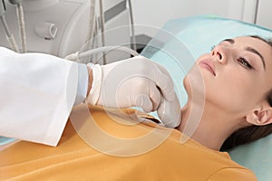 Doctor conducting ultrasound examination of patient`s neck