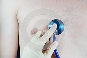 The doctor conducts auscultation of the patient, listening through a phonendoscope, pneumonia, cough