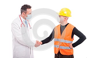 Doctor and constructor shaking hands like friends