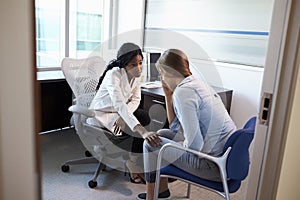 Doctor In Consultation With Depressed Female Patient