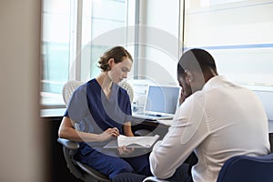 Doctor In Consultation With Depressed Male Patient