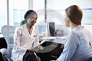 Doctor In Consultation With Female Patient In Office photo