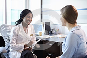 Doctor In Consultation With Female Patient In Office