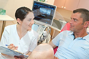 Doctor in consultation with male patient in office