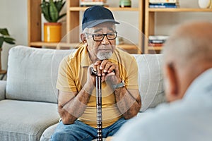 Doctor, consultation and senior man on sofa with walking stick or counselling discussion in therapy with psychologist