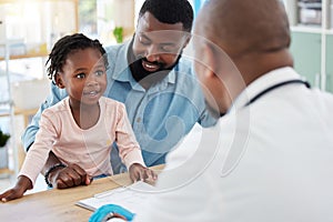 Doctor consulting with black family, baby and father in doctors office in hospital. Medicine wellness, healthy child