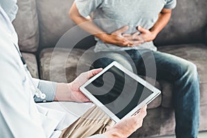 Doctor consulting diagnostic examining with patient presenting X-ray film results on digital tablet Visit the patient`s home