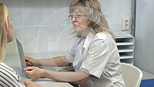 Doctor consulting her female patient in her office