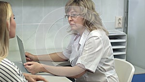 Doctor consulting her female patient in her office