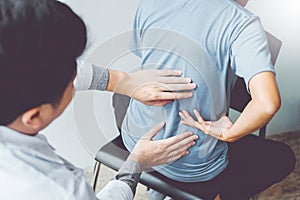 Doctor consulting with patient Back problems Physical therapy co photo