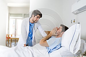 Doctor consulting patient lying on hospital bed talking worried giving bad news about the diagnose