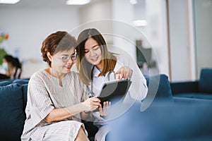 doctor consulting senior patient at health care clinic