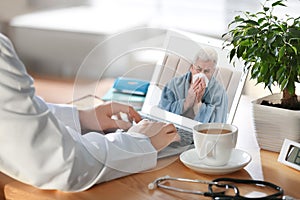 Doctor consulting sick patient online by video chat in medical office