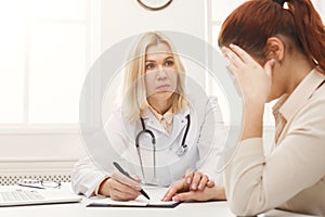 Doctor consulting woman in hospital