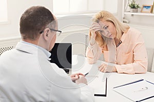 Doctor consulting woman in hospital