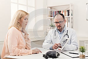 Doctor consulting woman in hospital