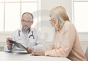 Doctor consulting woman in hospital