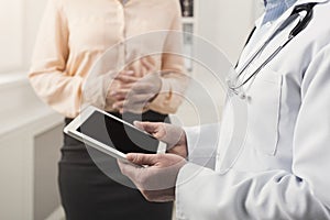 Doctor consulting woman in hospital