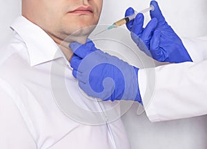 Doctor cosmetologist makes a man an injection of plasma therapy in a double chin, treatment plasma-lifting, close-up