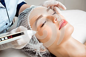 The doctor cosmetologist makes the Rejuvenating facial injections procedure for tightening and smoothing wrinkles on the