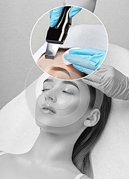 The doctor-cosmetologist makes the ultrasound cleaning procedure of the facial skin of a beautiful, young woman