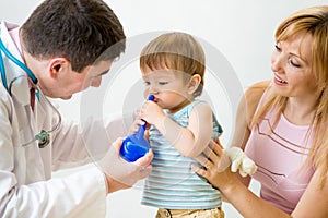 Doctor counseling mother and child about nasal irrigation or douch
