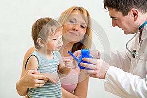 doctor counseling mother and kid about nasal irrigation or douche with neti pot