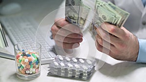 Doctor counting money in medical office. Pharmacy prescription in doctors office