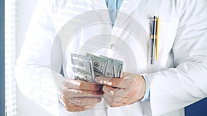 Doctor counting money in medical office. Pharmacy prescription in doctors office