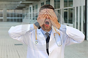 Doctor covering his eyes with the hands