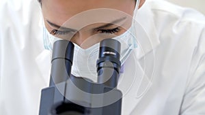 Doctor, covid or scientist woman with microscope in science lab for DNA research, medical and medicine data analysis