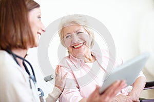 Doctor delivers the good news - Senior Care. Elderly patient is delighted by the good news her nurse has just given her.