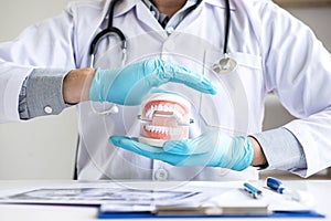 Doctor dentist protection dental tooth model on workplace with x-ray film