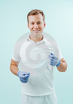 Doctor dentist smiling without medical mask in dental clinic on light background. Smile healthy teeth concept