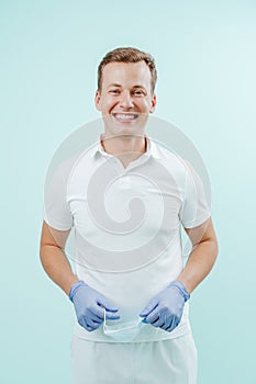 Doctor dentist smiling without medical mask in dental clinic on light background. Smile healthy teeth concept