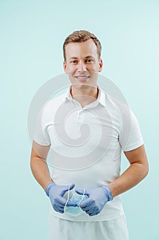 Doctor dentist smiling without medical mask in dental clinic on light background. Smile healthy teeth concept