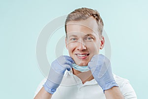 Doctor dentist smiling without medical mask in dental clinic on light background. Smile healthy teeth concept