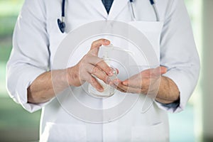 doctor desinfecting hands