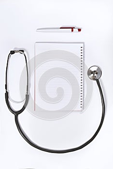 Doctor desk.Stethoscope notebook and pen on white background