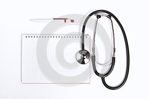 Doctor desk.Stethoscope notebook and pen on white background